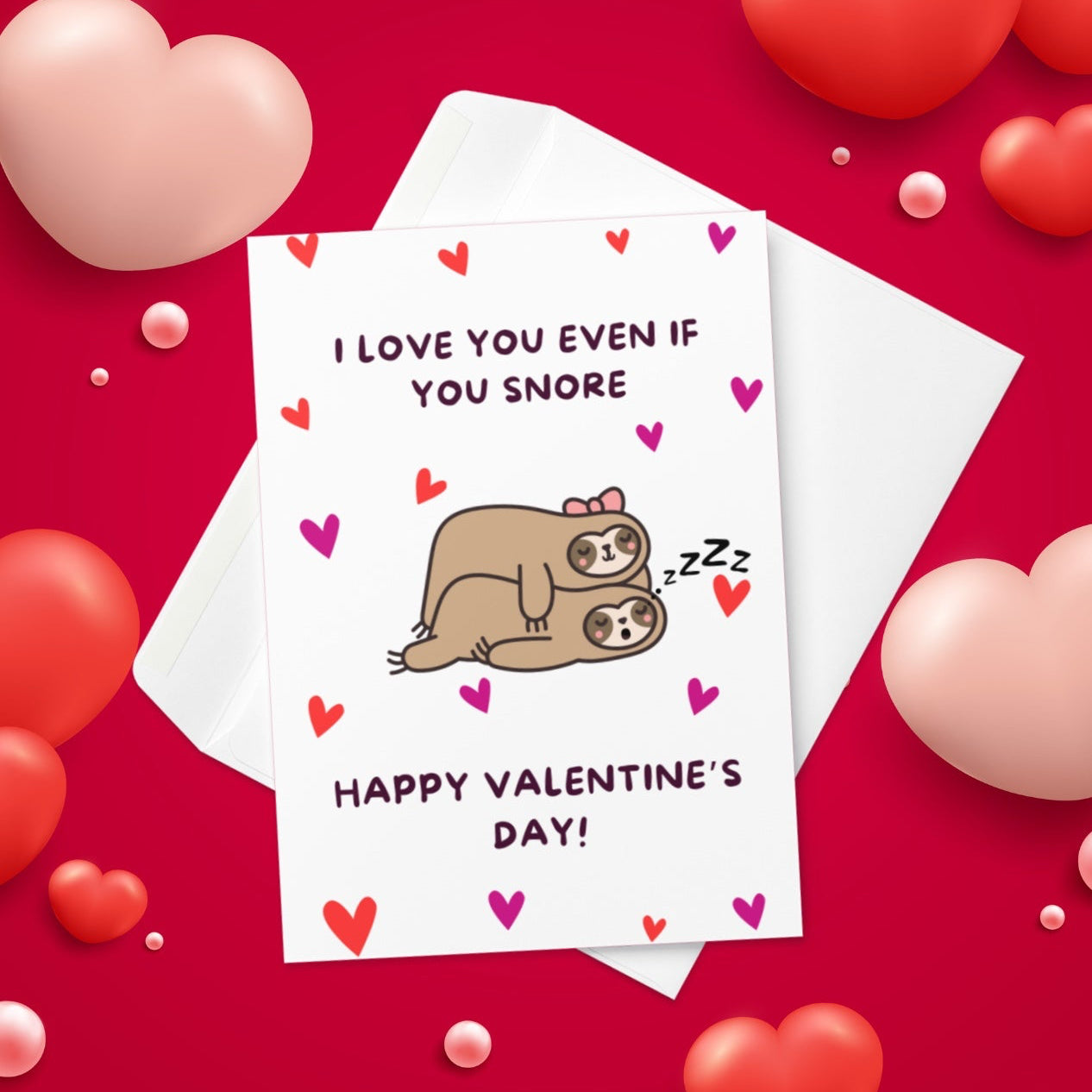 A funny Valentine’s Day card with an image of two sloths sleeping, and one of them snoring, with the quote I love you even if you snore!