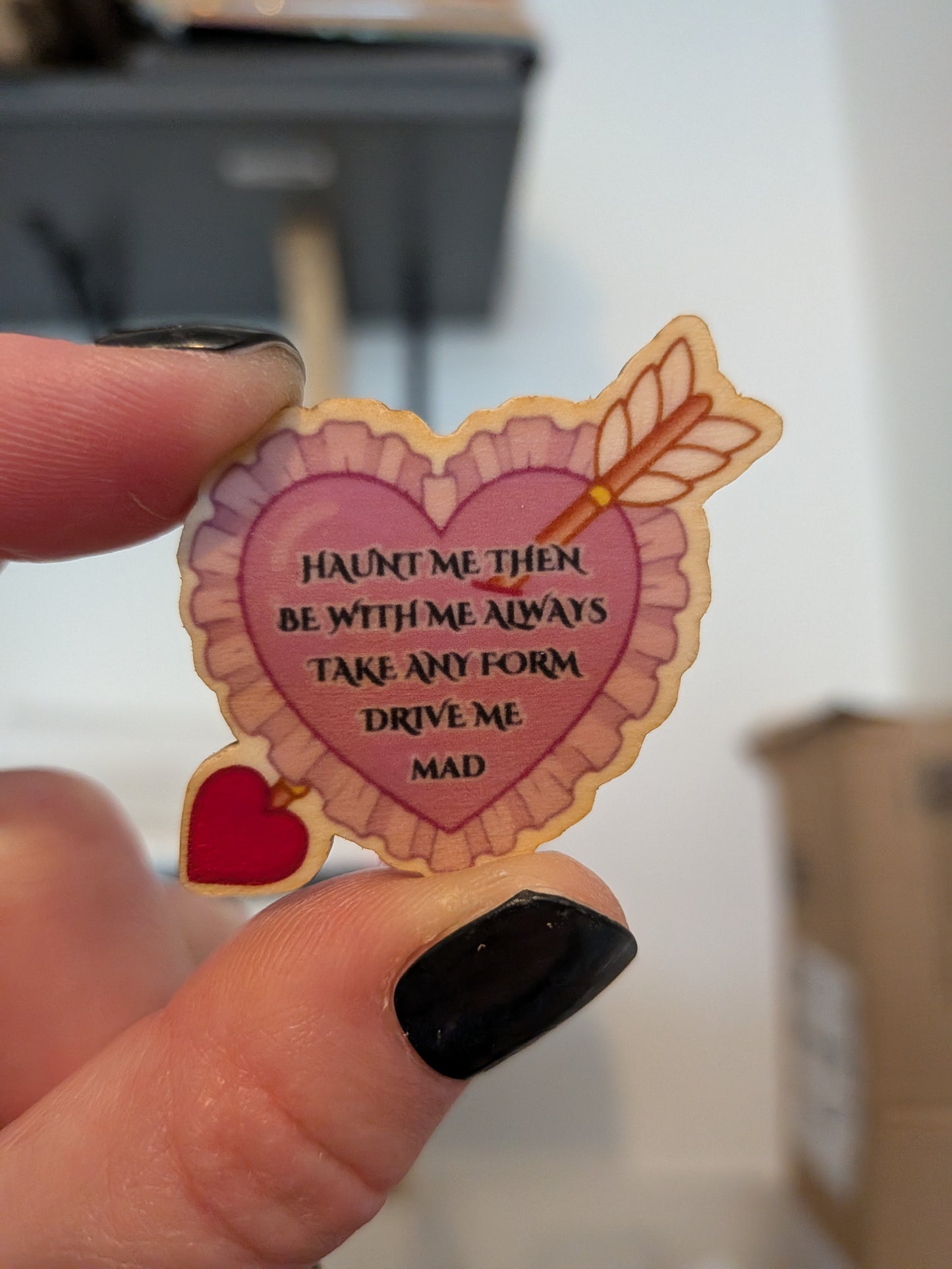 home made eco friendly wooden pin with a heart and an arrow, and the quote by Heathcliff towards Cathy "haunt me then. Be with me always. Take any form. Drive me mad."

Inspired by Wuthering Heights